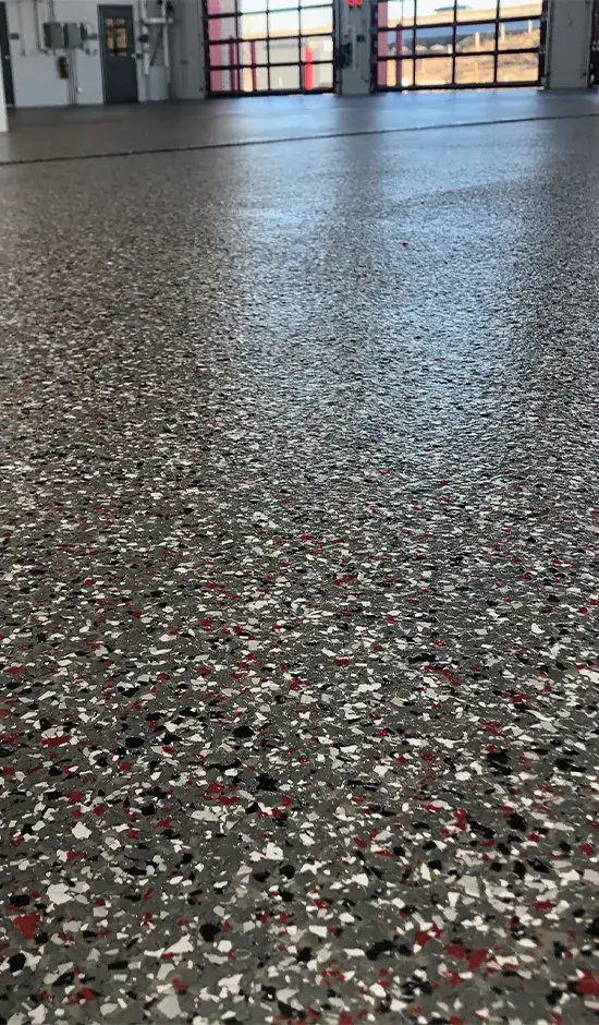 Gray, black and red speckled flake epoxy floor in a multi-bay commercial garage, Las Vegas NV